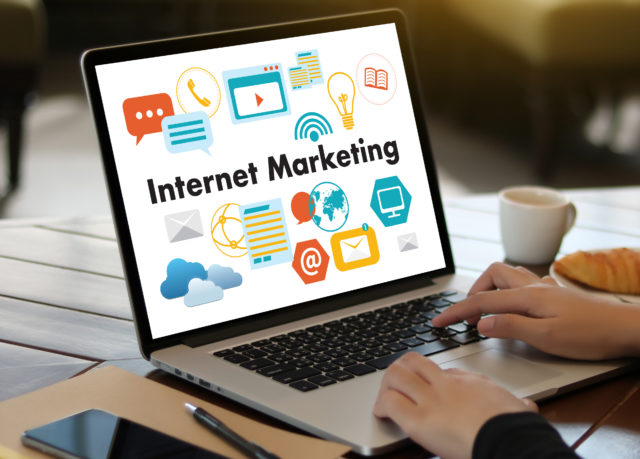 IOT business man hand working and internet of things (IoT) word diagram as concept use Browsing Internet computer Searching Data Internet Marketing